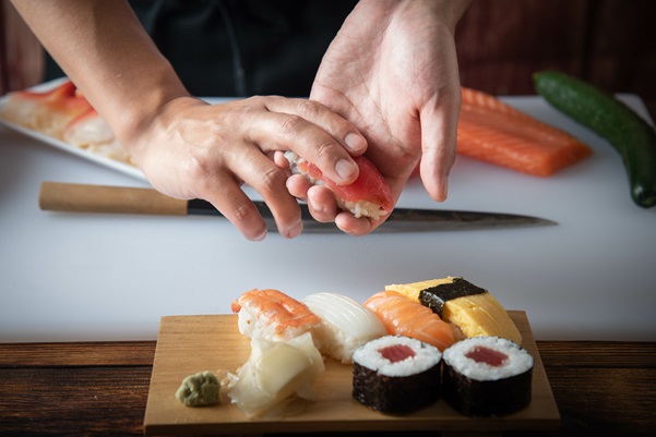 japanese sushi chef making nigiri sushi