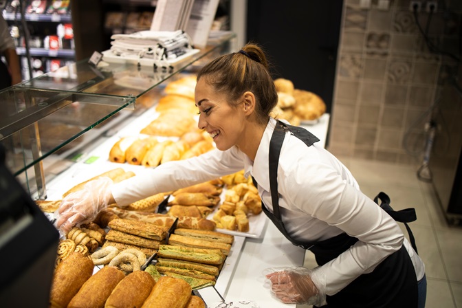 Woman preparing pastry for sale