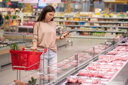 Woman Choosing Meat In Store