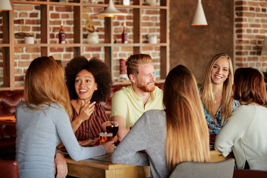 Group of people having conversation at a table