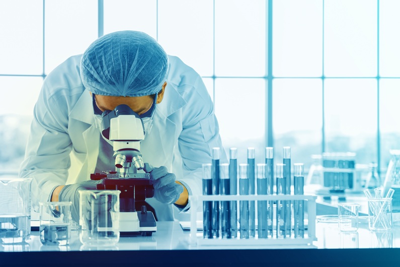 Scientists are using a microscope to test for bacteria in the laboratory.