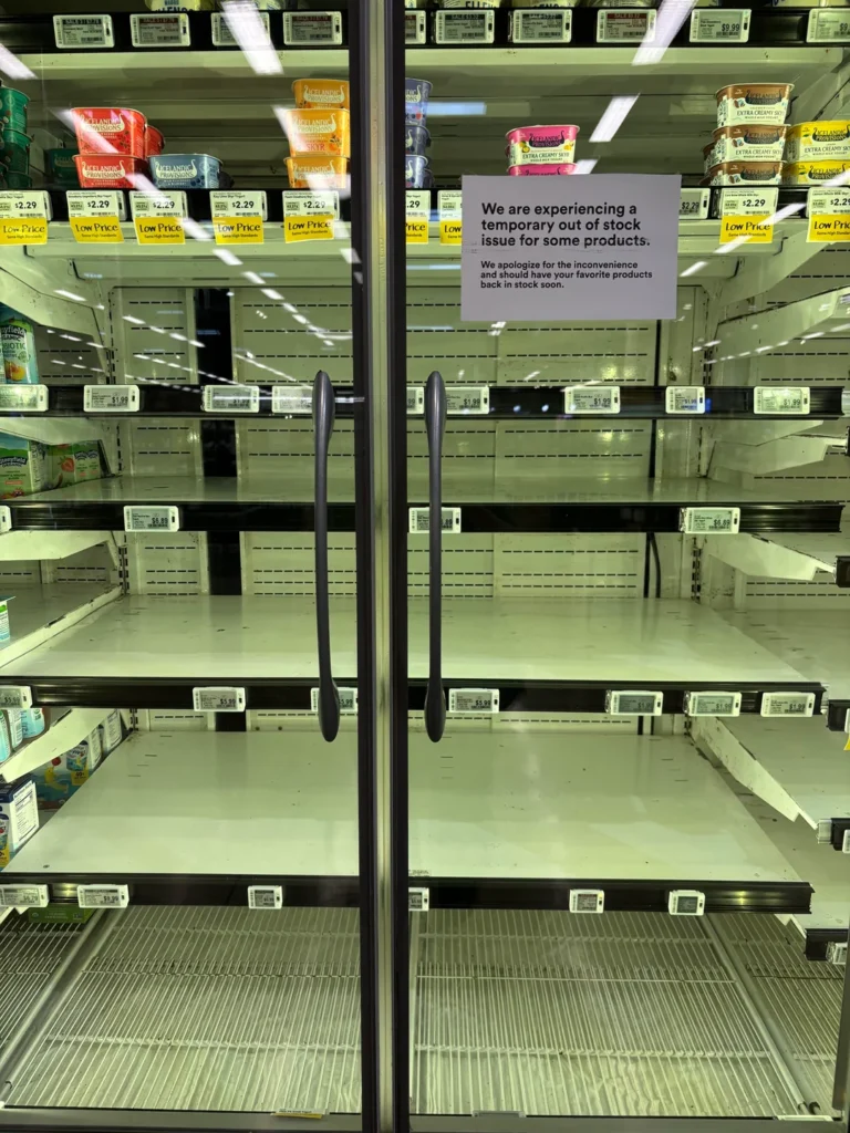 A post on Reddit shows an empty refrigerator with a sign reading the store is “experiencing a temporary out of stock issue for some products.