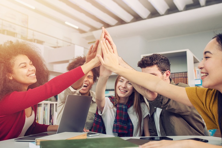 Students putting their hands together