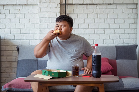 Fat men are happy with eating pizza and soft drinks.