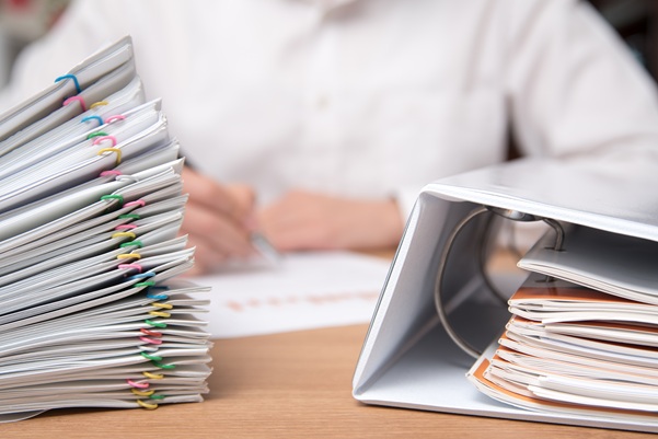 A pile of documents with the man in the document