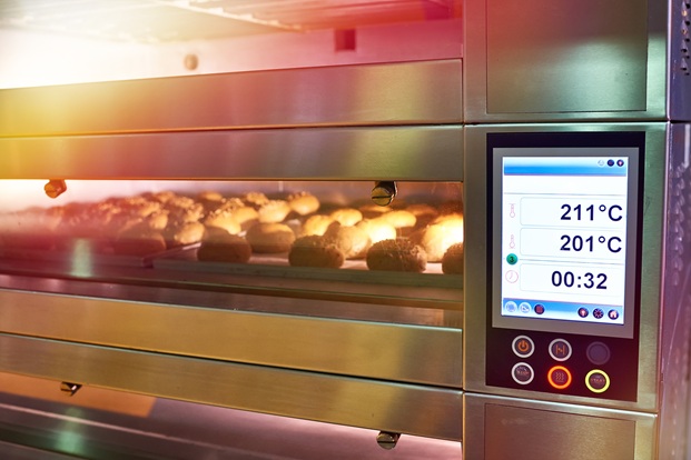 LCD screen of oven with bread in bakery